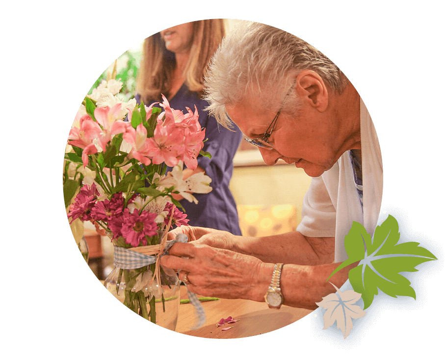 Mobile1-img senior woman looking at bouquet of flowers